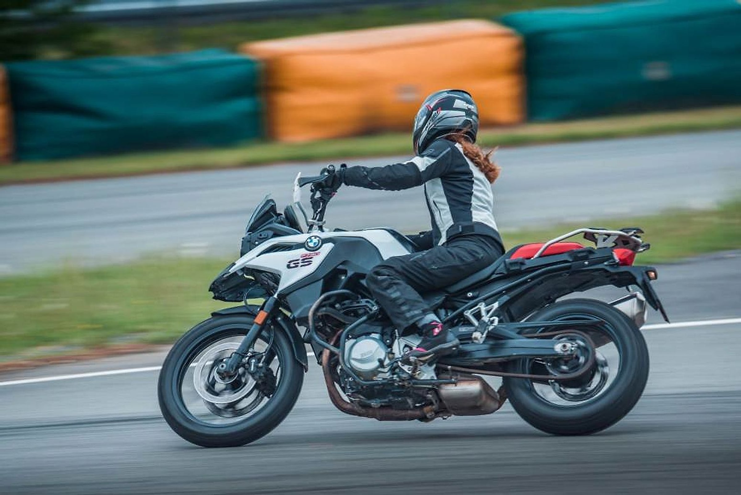 Jezdkyně na BMW F 750 GS projíždí zatáčkou závodního okruhu